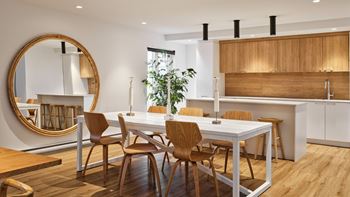 A modern kitchen with a dining table and chairs.